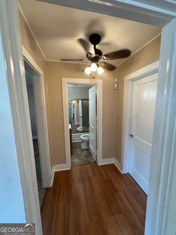 a view of hallway with wooden floor