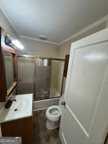 a bathroom with a sink toilet a mirror and shower