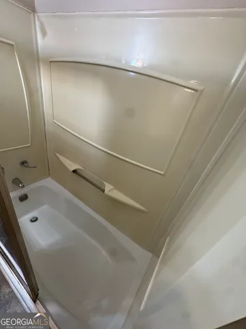 a bathroom with a tub and a shower