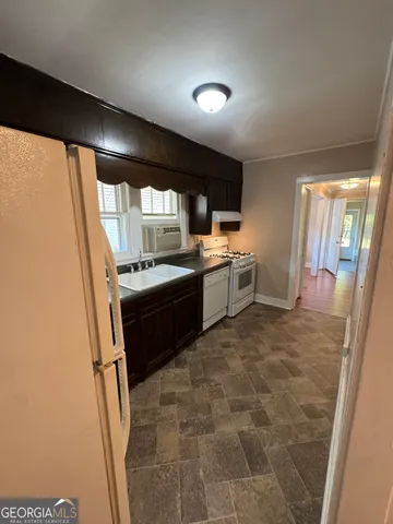 a kitchen with a stove a sink and a refrigerator