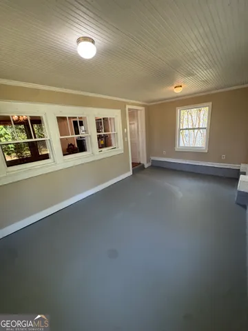 a view of a livingroom with an empty space and a window