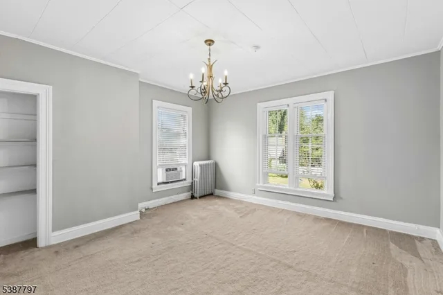 a view of a chandelier in big room and chandelier