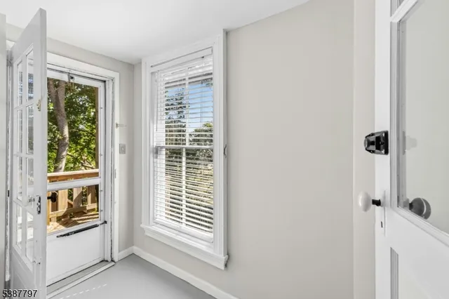 a room with a window and a kitchen view