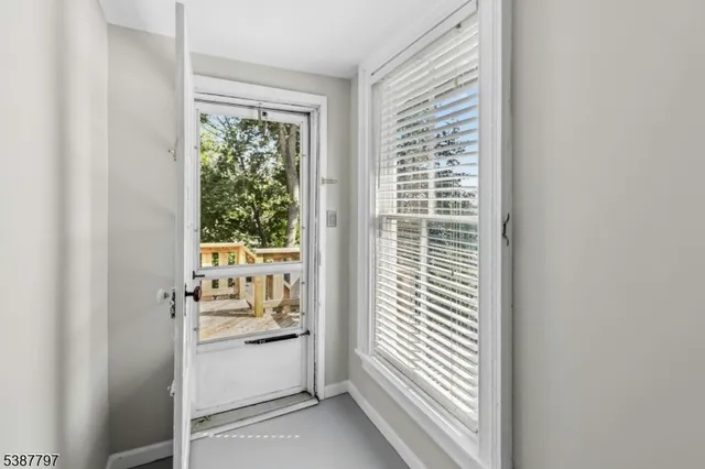 a view of deck with furniture and trees around