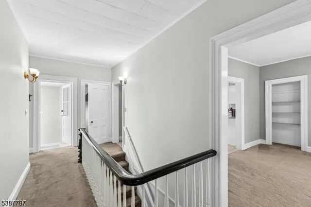 a kitchen with stainless steel appliances granite countertop a refrigerator a sink dishwasher and white cabinets with wooden floor