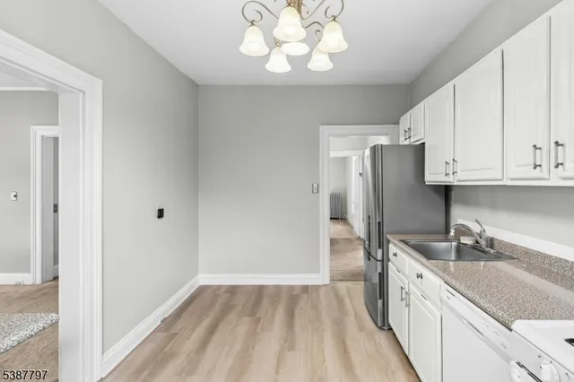 a kitchen with a stove a refrigerator and a sink