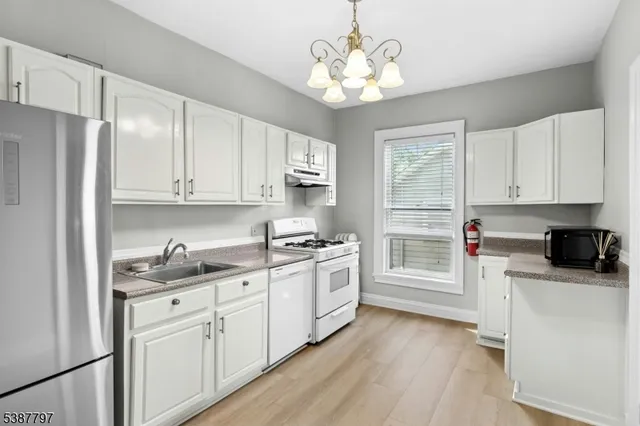 a bathroom with a granite countertop sink a bathtub and a shower