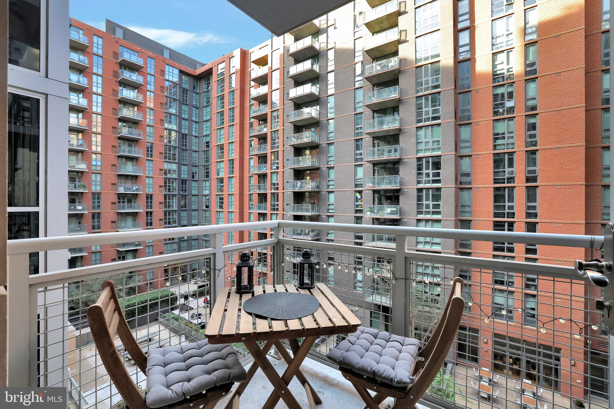 1025 First Street Southeast, Unit 602 Washington, DC 20003 - Photo 14 of 49 a view of a building from a chairs and table in the balcony