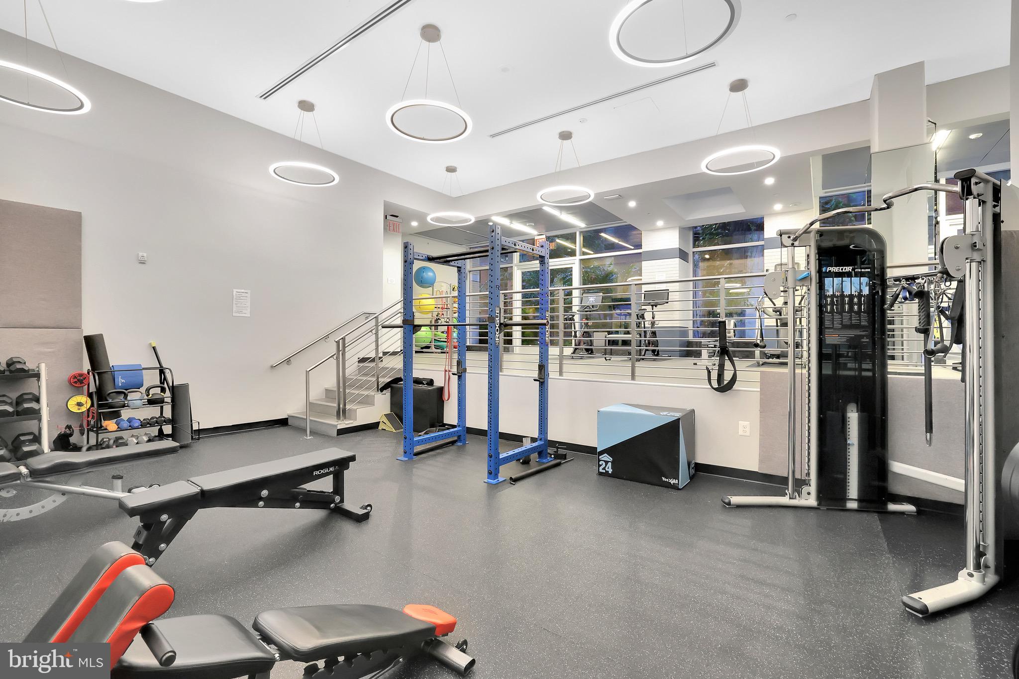 1025 First Street Southeast, Unit 602 Washington, DC 20003 - Photo 39 of 49 a room with gym equipment and a view of living room