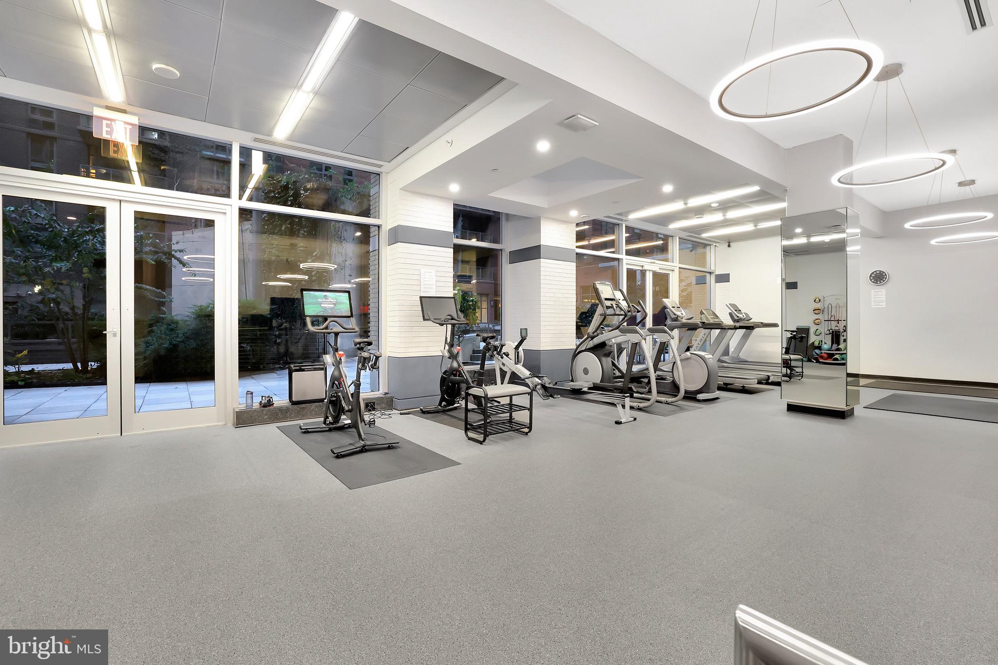 1025 First Street Southeast, Unit 602 Washington, DC 20003 - Photo 40 of 49 a room with gym equipment and mirrors