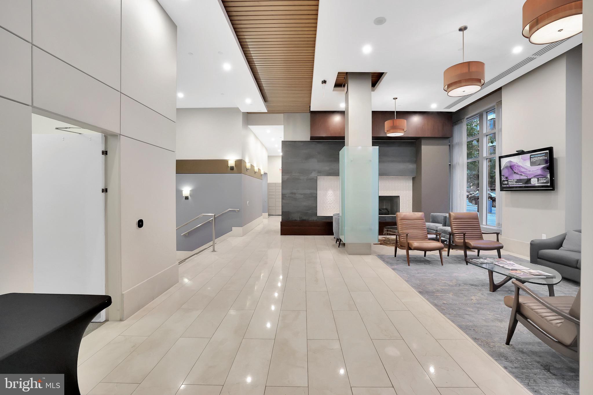 1025 First Street Southeast, Unit 602 Washington, DC 20003 - Photo 45 of 49 a living room with stainless steel appliances furniture a rug and a large window