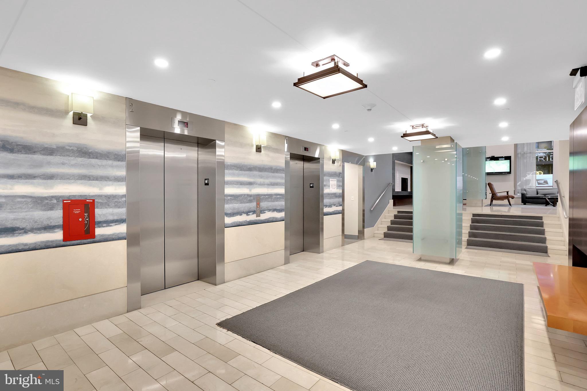 1025 First Street Southeast, Unit 602 Washington, DC 20003 - Photo 46 of 49 a kitchen with stainless steel appliances kitchen island granite countertop a refrigerator and a stove top oven