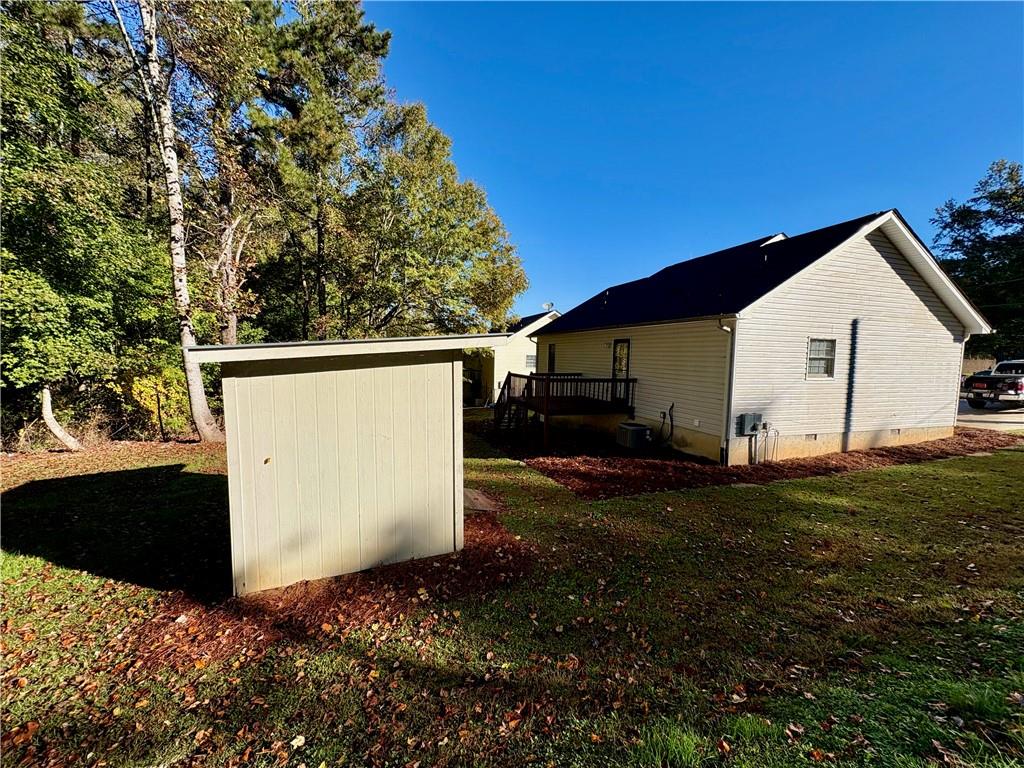 208 Maple Street Dawsonville, GA 30534 - Photo 18 of 21 a view of a white house with a yard