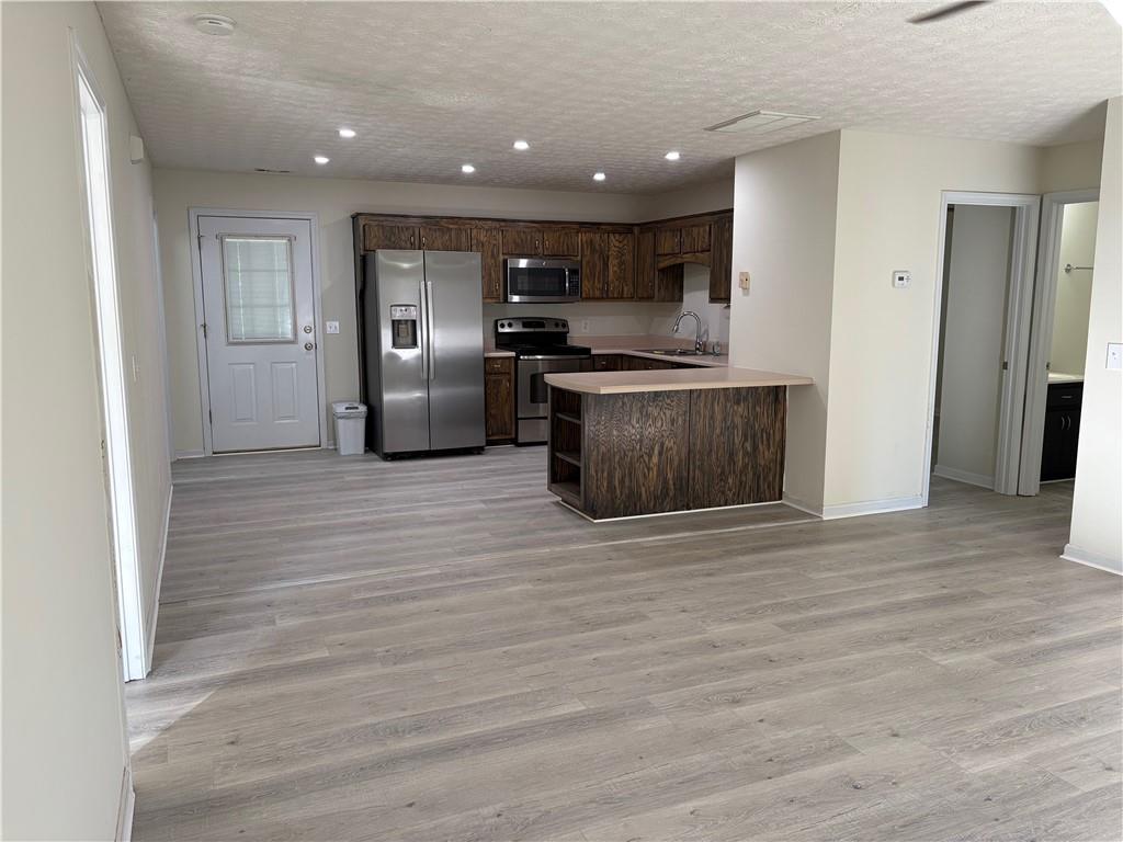 208 Maple Street Dawsonville, GA 30534 - Photo 2 of 21 a kitchen with stainless steel appliances granite countertop a refrigerator and a sink