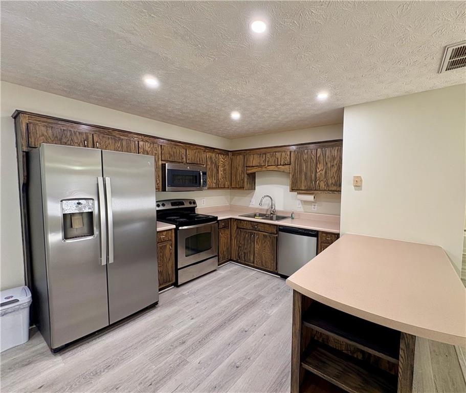 208 Maple Street Dawsonville, GA 30534 - Photo 7 of 21 a kitchen with a refrigerator sink and microwave