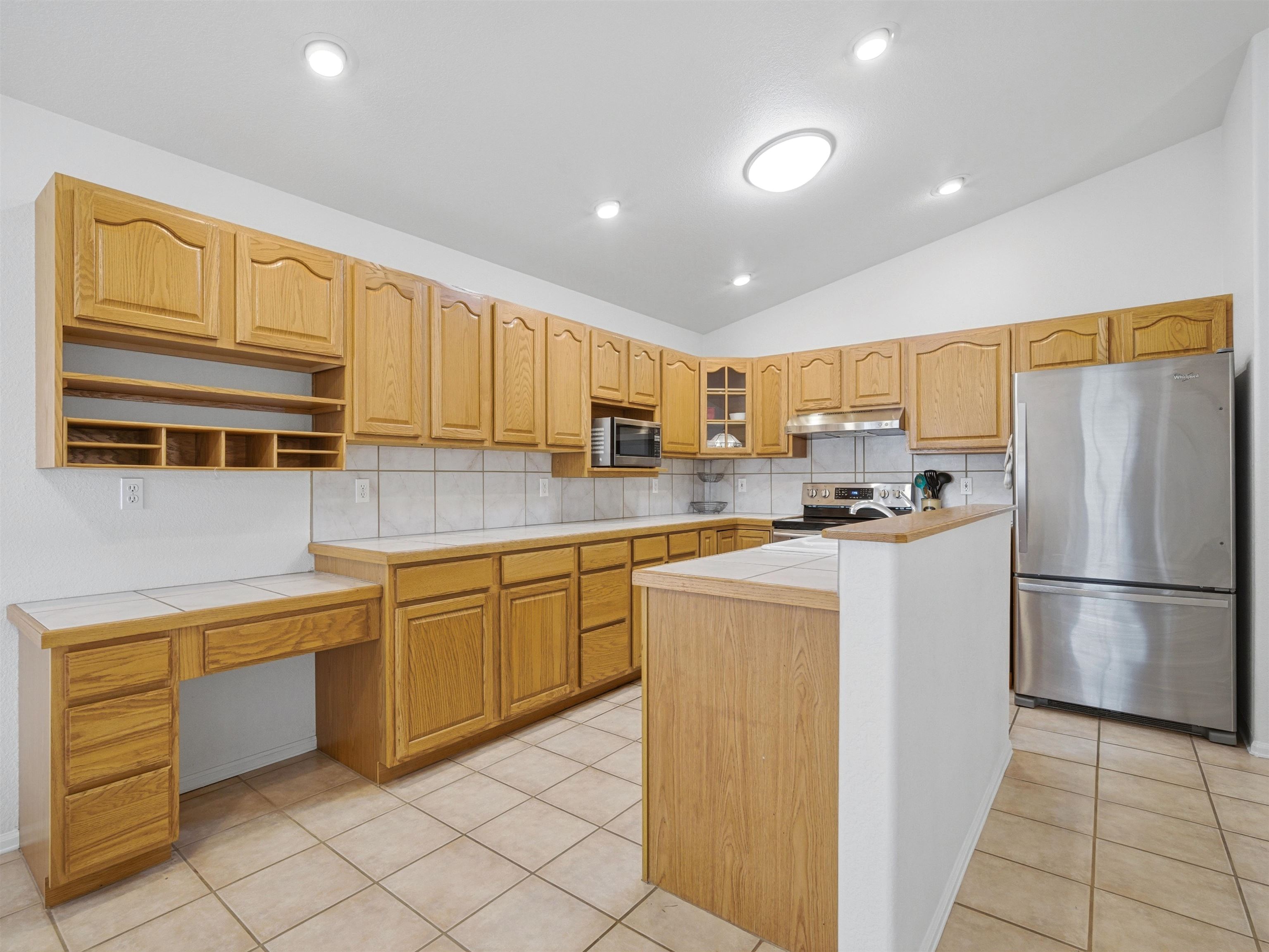 3082 Shadowbrook Court Grand Junction, CO 81504 - Photo 8 of 28 a kitchen with stainless steel appliances granite countertop a refrigerator sink and cabinets
