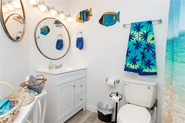 a bathroom with a toilet and a shower curtain