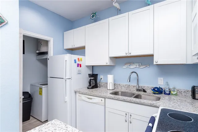 a kitchen with white cabinets and a sink