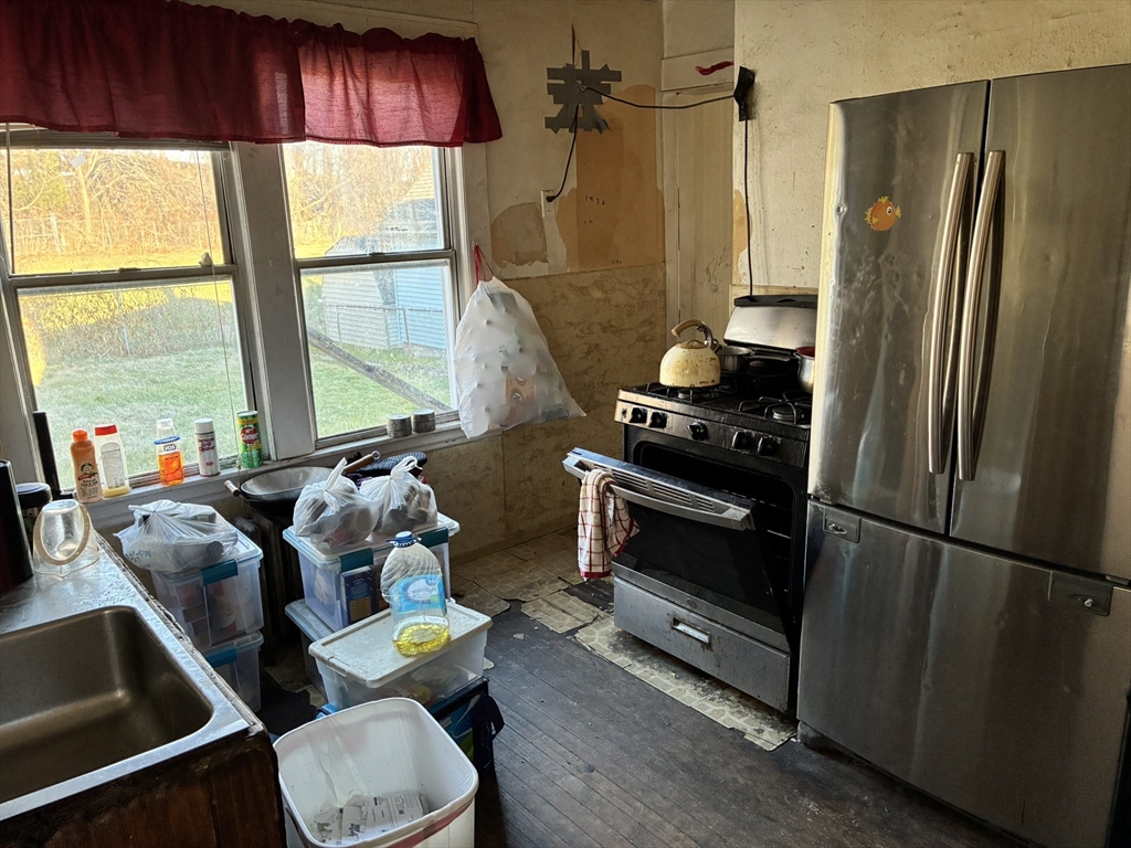 188 Windsor Street West Springfield, MA 01089 - Photo 10 of 13 a kitchen with stainless steel appliances a refrigerator and a window