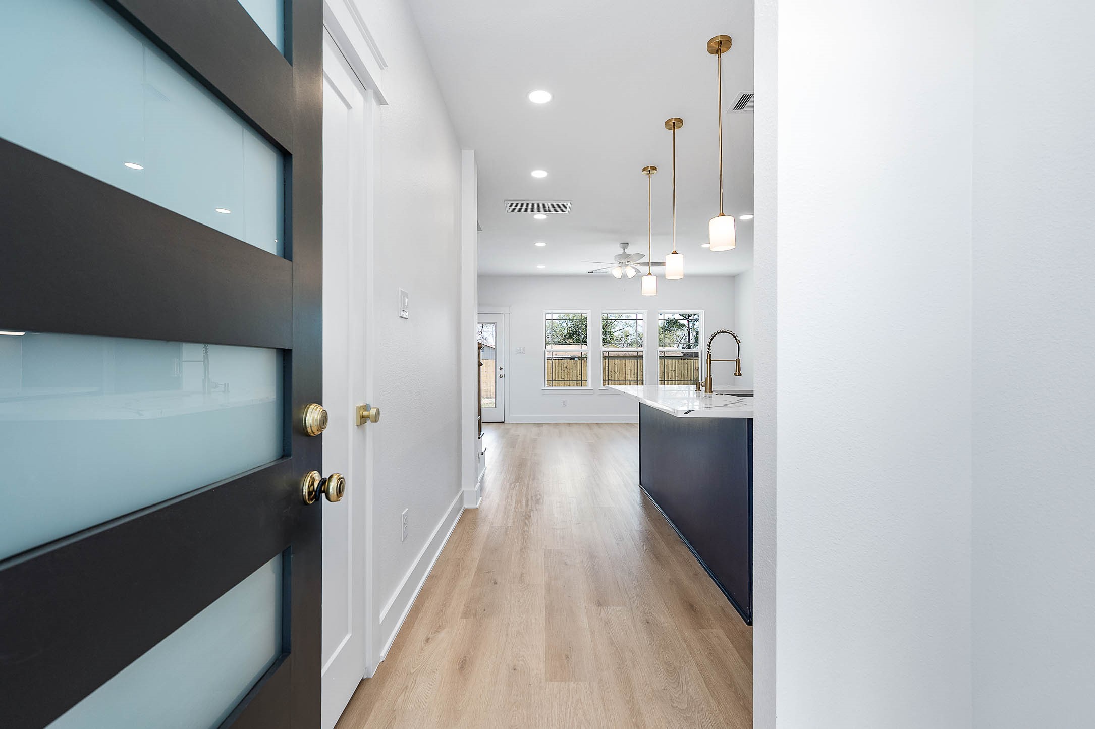 8602 Hoffman Street Houston, TX 77016 - Photo 2 of 30 Welcoming entry view opening into a bright, open-concept living and kitchen area with modern finishes.