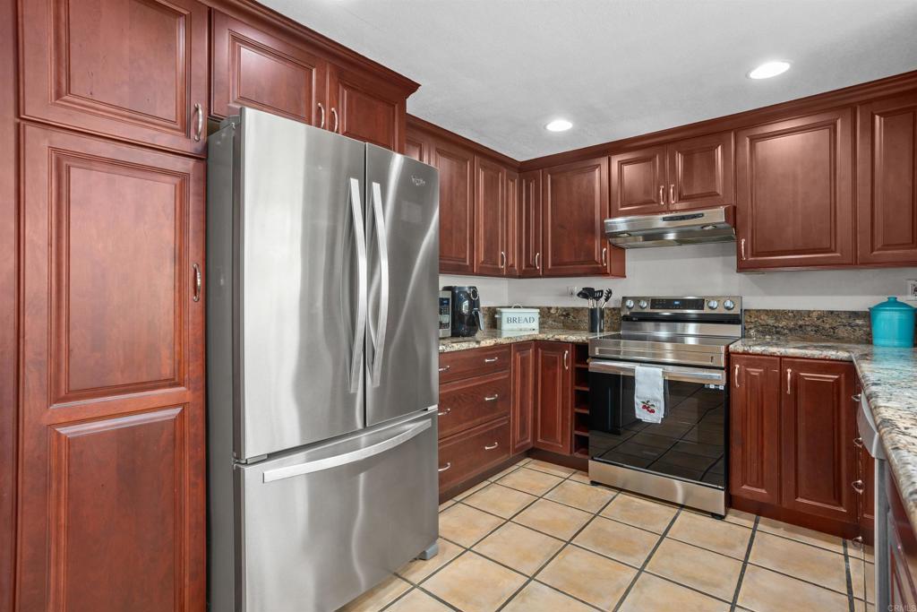 1991 Paseo Del Rey Vista, CA 92084 - Photo 17 of 42 a kitchen with granite countertop stainless steel appliances and cabinets