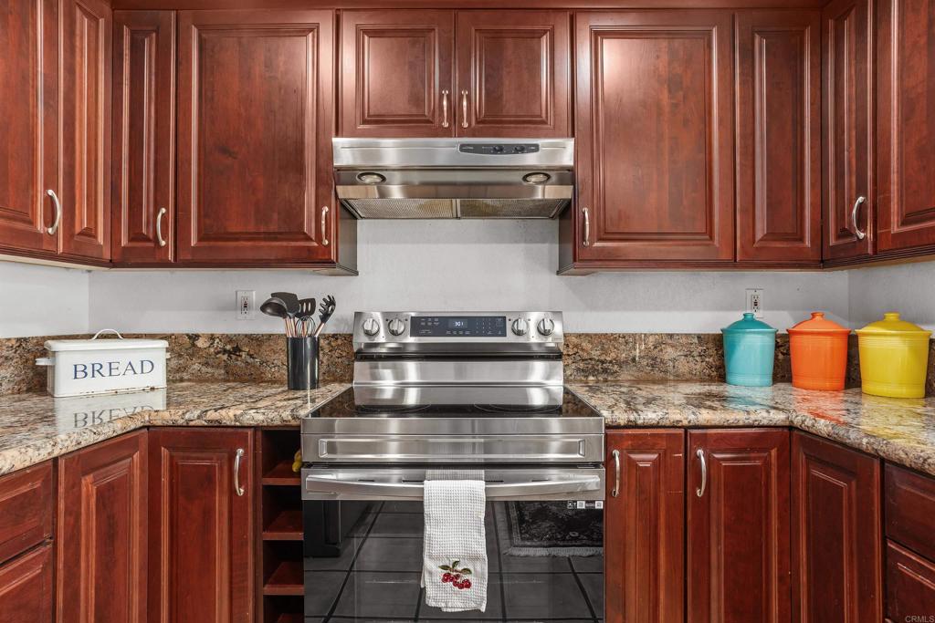 1991 Paseo Del Rey Vista, CA 92084 - Photo 18 of 42 a kitchen with granite countertop stainless steel appliances wooden cabinets and a counter top