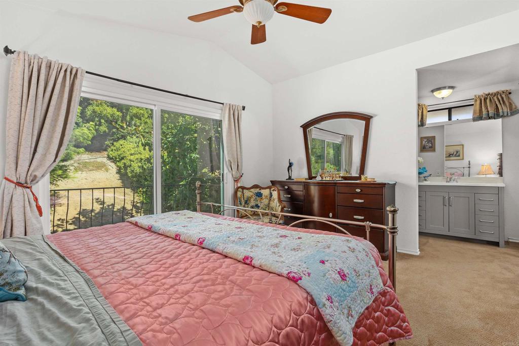 1991 Paseo Del Rey Vista, CA 92084 - Photo 30 of 42 a bedroom with a bed and a large window