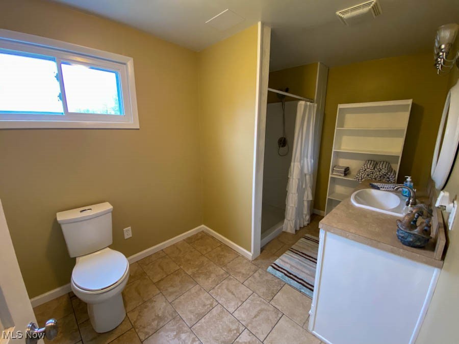 751 Garrison Road Ashtabula, OH 44004 - Photo 12 of 19 Full bath with toilet, vanity, visible vents, a stall shower, and baseboards