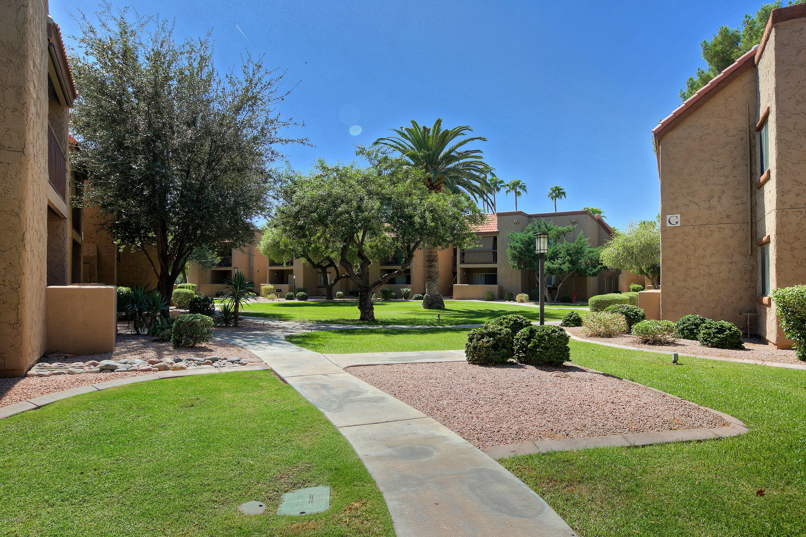 8256 East Arabian Trail, Unit 134 Scottsdale, AZ 85258 - Photo 1 of 24 a view of a house with a yard and sitting area