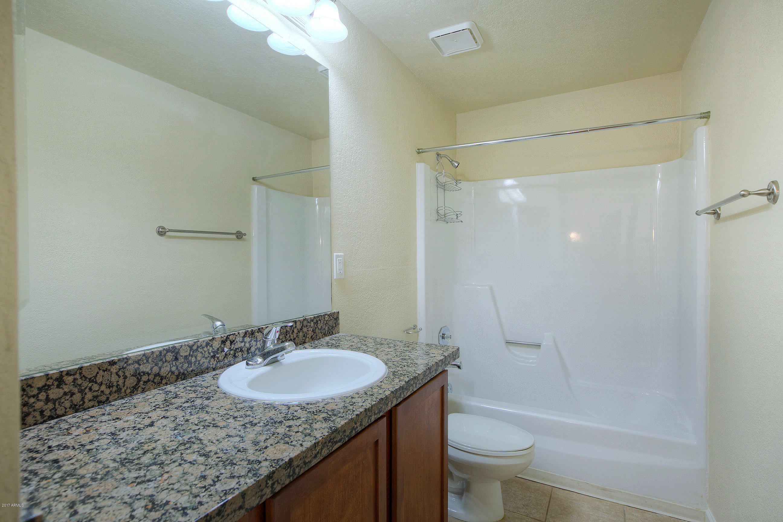 8256 East Arabian Trail, Unit 134 Scottsdale, AZ 85258 - Photo 13 of 24 a bathroom with a granite countertop sink a toilet and shower