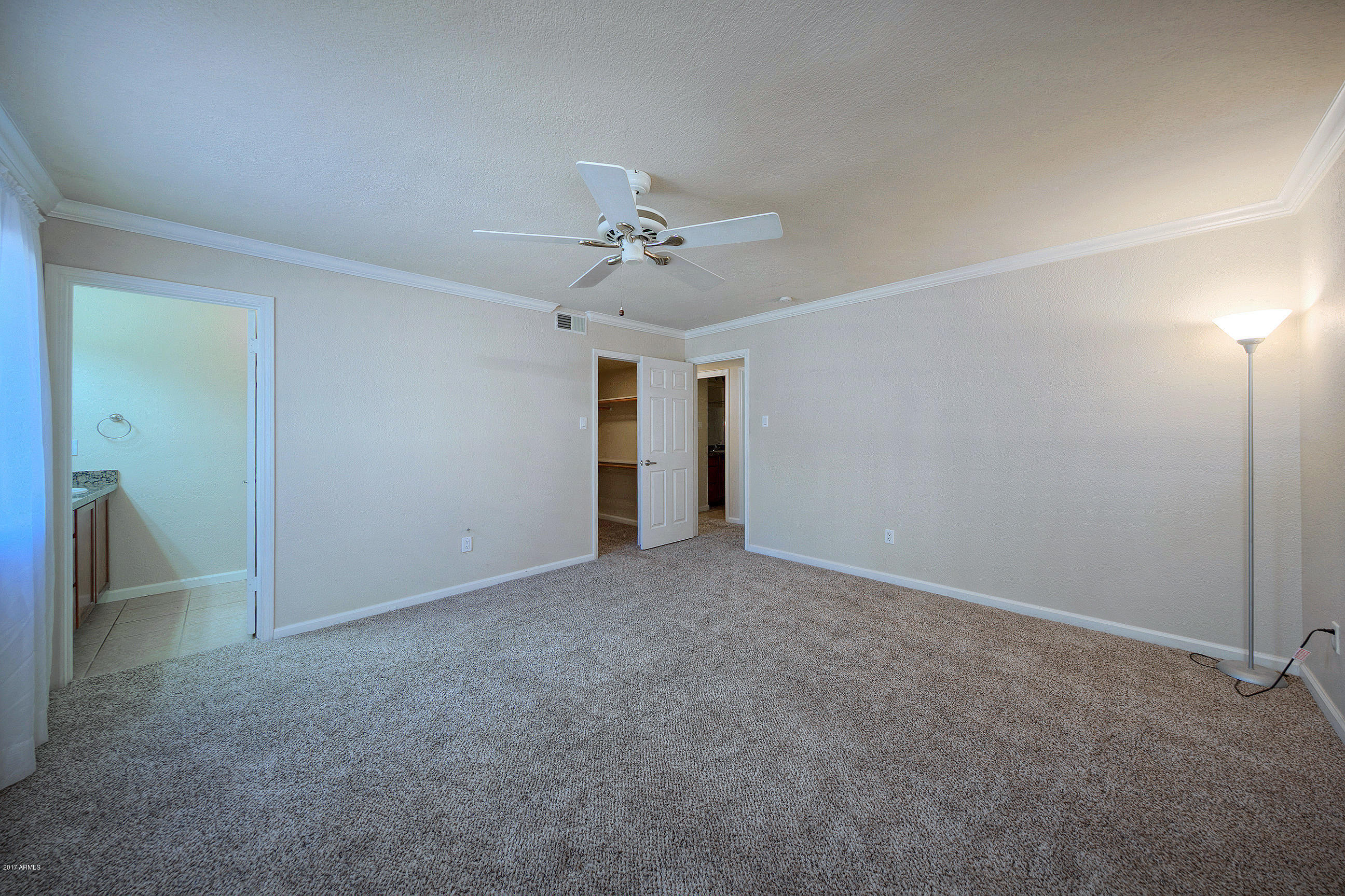 8256 East Arabian Trail, Unit 134 Scottsdale, AZ 85258 - Photo 16 of 24 an empty room with a ceiling fan and a window