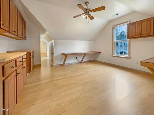 a bathroom with a granite countertop sink a toilet and a mirror