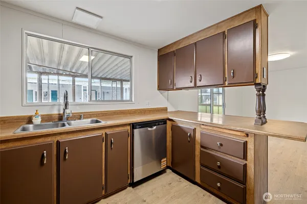 a kitchen with a sink window and cabinets