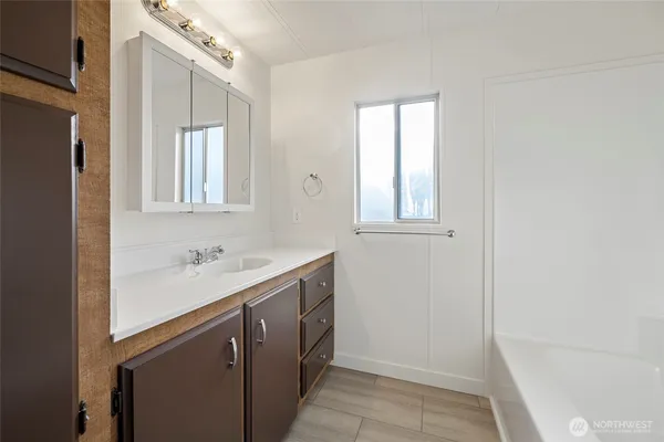 a bathroom with a sink a mirror and a bathtub