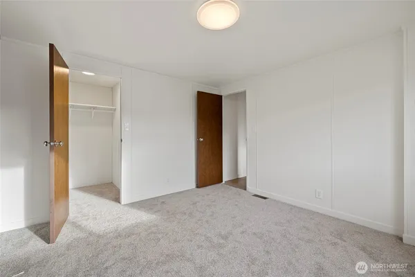 an empty room with closet area