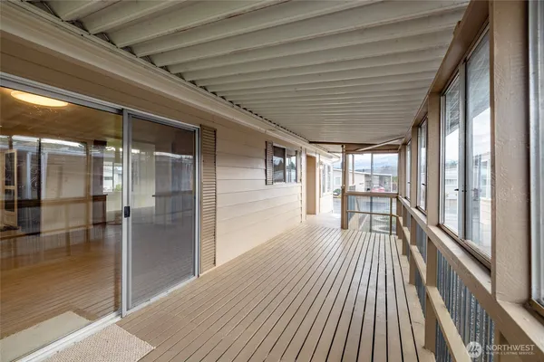 a view of a porch with wooden floor and outdoor space