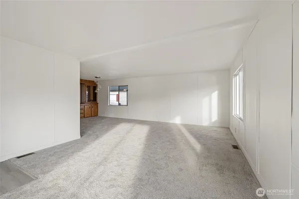 a view of a big room with windows and cabinet
