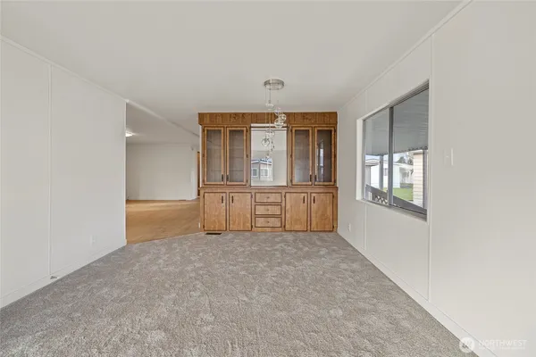 an empty room with windows and pillars in it