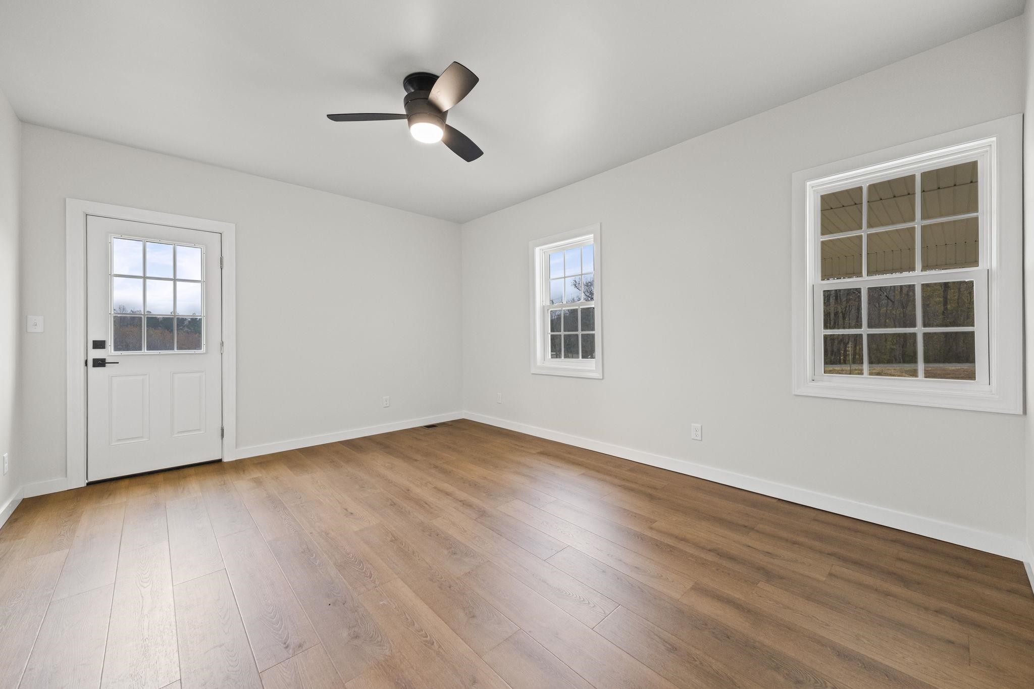 835 Curve Woodville Road Gates, TN 38037 - Photo 13 of 30 Spare room with light wood finished floors, plenty of natural light, and a ceiling fan