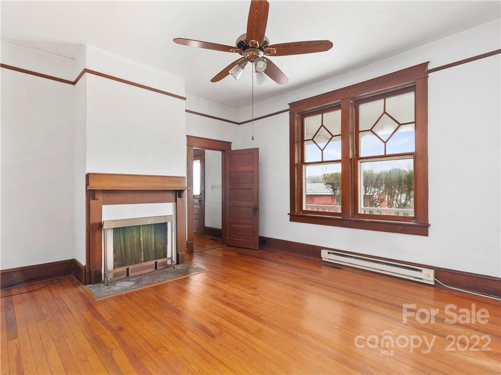 5593 Old Clyde Road Clyde, NC 28721 - Photo 13 of 35 a view of an empty room with window and fire place