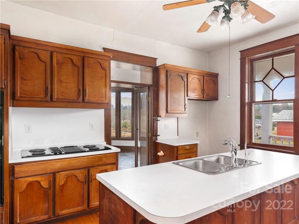 5593 Old Clyde Road Clyde, NC 28721 - Photo 17 of 35 a kitchen with stainless steel appliances granite countertop a sink stove and cabinets