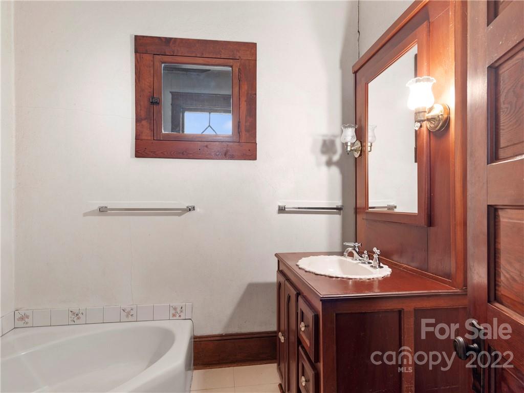 5593 Old Clyde Road Clyde, NC 28721 - Photo 25 of 35 a bathroom with a sink and a bathtub