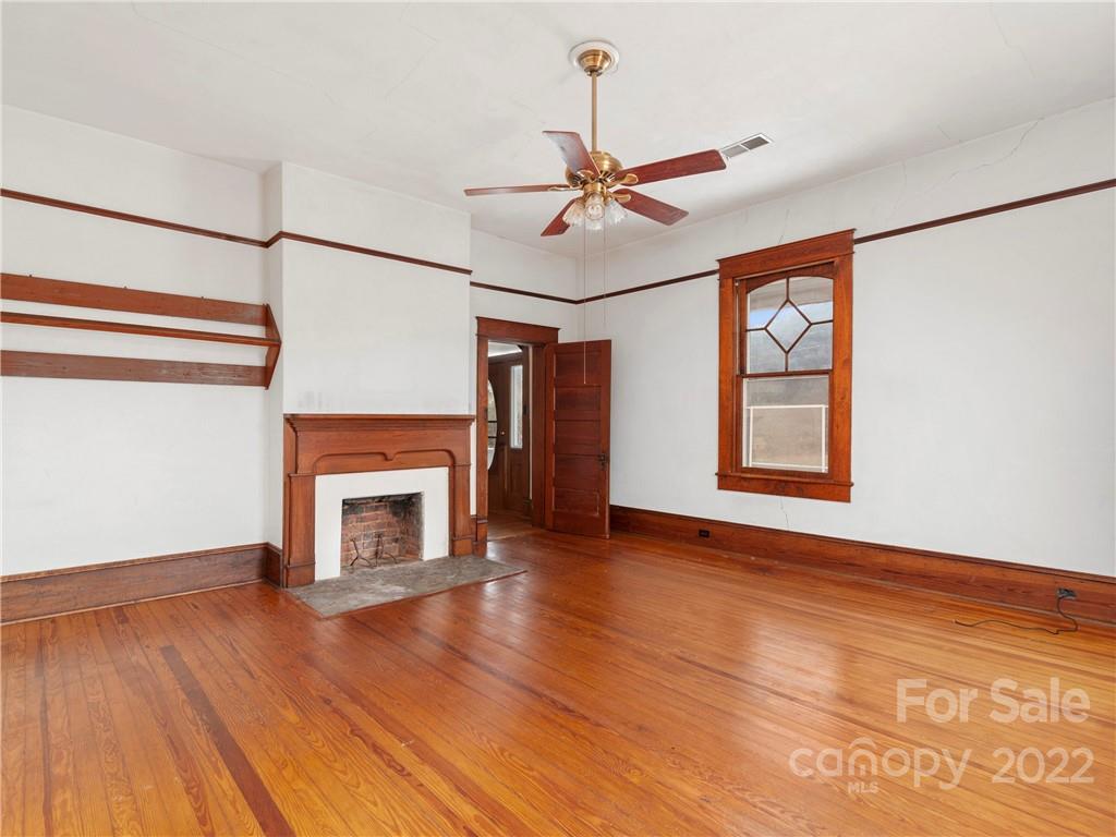 5593 Old Clyde Road Clyde, NC 28721 - Photo 28 of 35 a view of an empty room with window and wooden floor