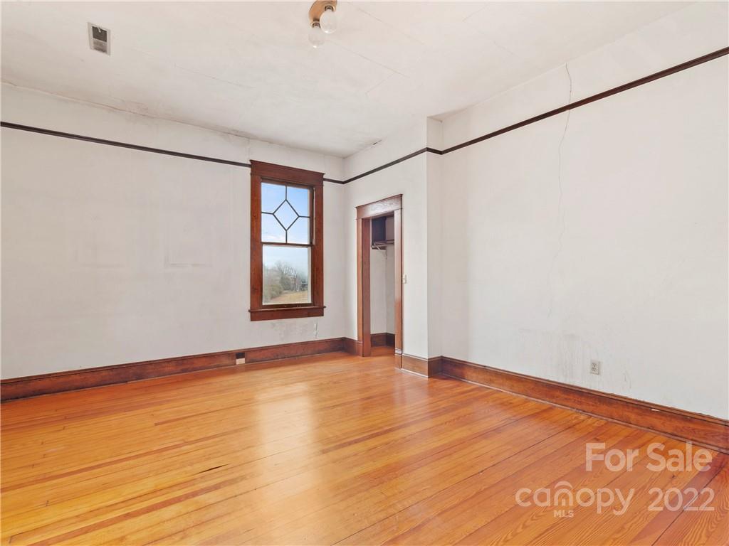 5593 Old Clyde Road Clyde, NC 28721 - Photo 29 of 35 a view of an empty room with window and wooden floor