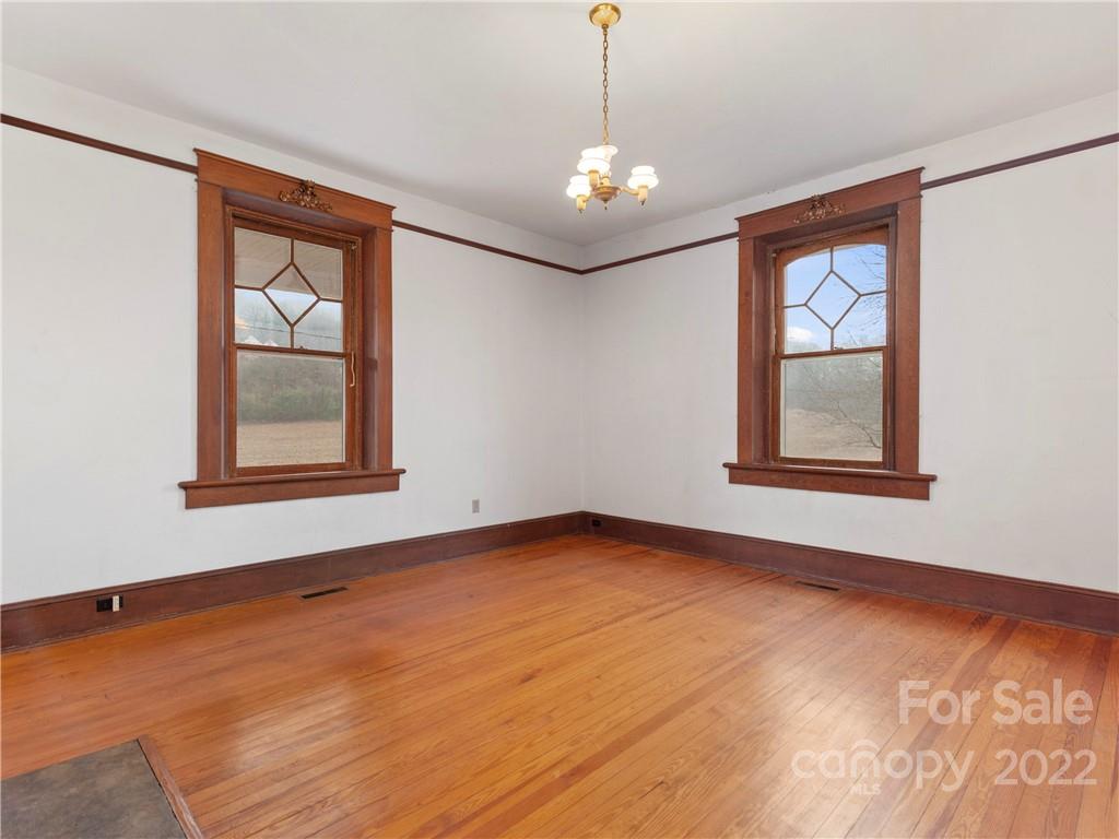 5593 Old Clyde Road Clyde, NC 28721 - Photo 6 of 35 a view of an empty room with window and wooden floor