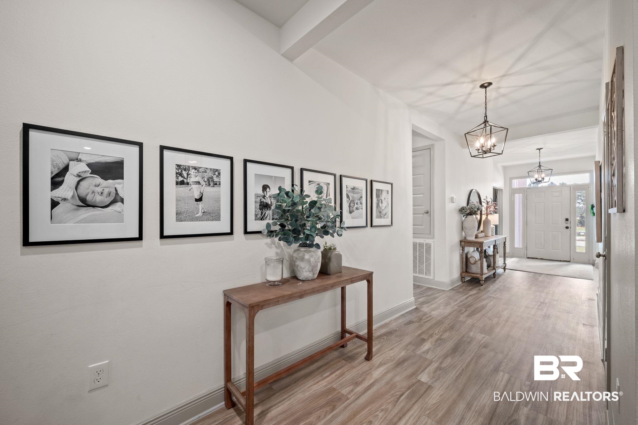 10169 Dunleith Loop Daphne, AL 36526 - Photo 19 of 40 Corridor with wood finished floors and a chandelier