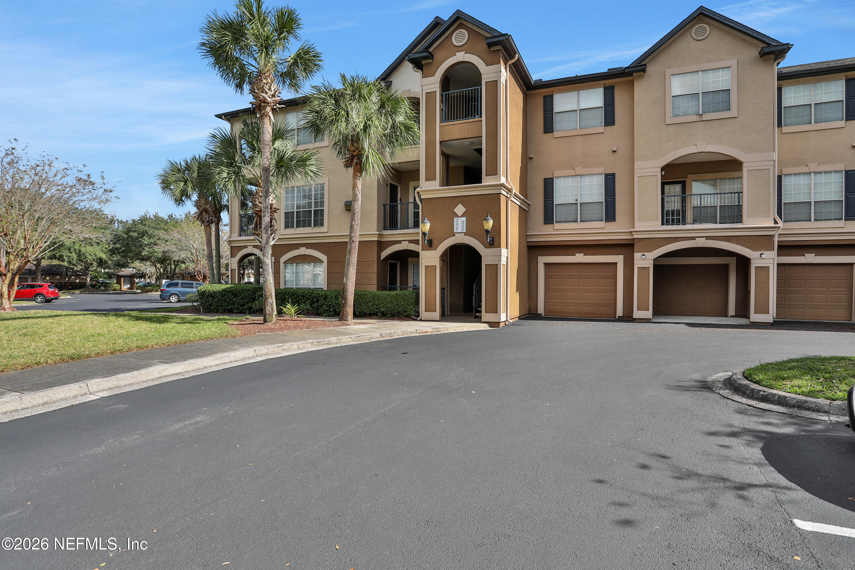 10961 Burnt Mill Road, Unit 425 Jacksonville, FL 32256 - Photo 6 of 35 a front view of a house with a yard