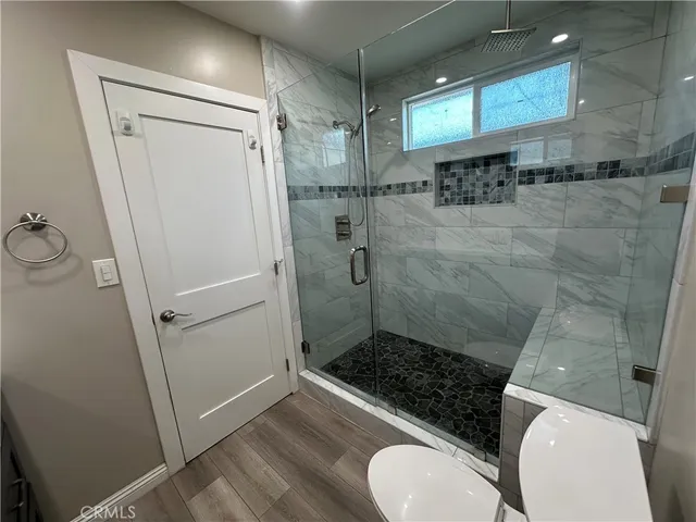 a bathroom with a toilet and a shower