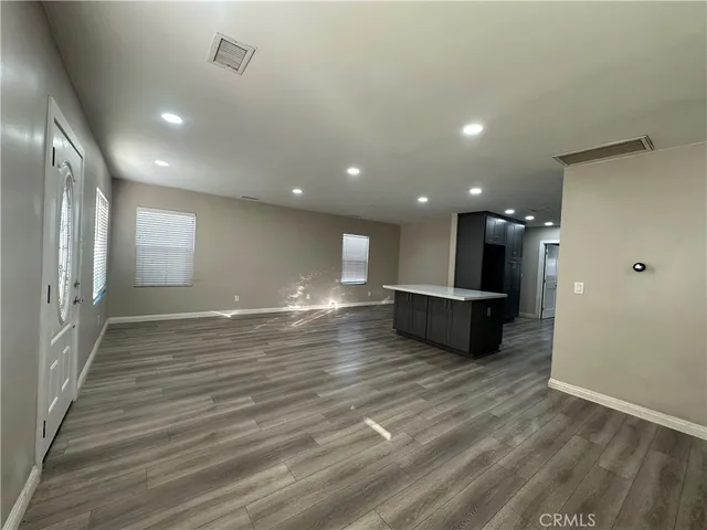a view of a room with wooden floor and a window