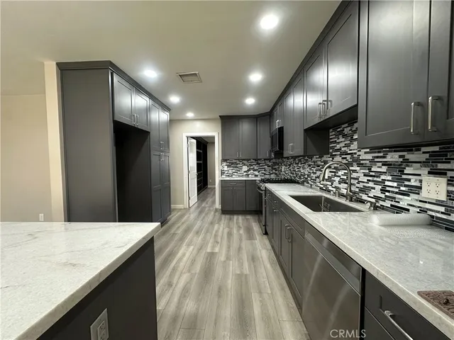 a kitchen with a sink stove and refrigerator